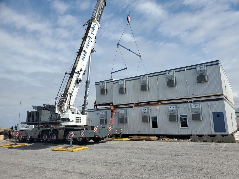 Two story modular building with the upper modules being set by crane