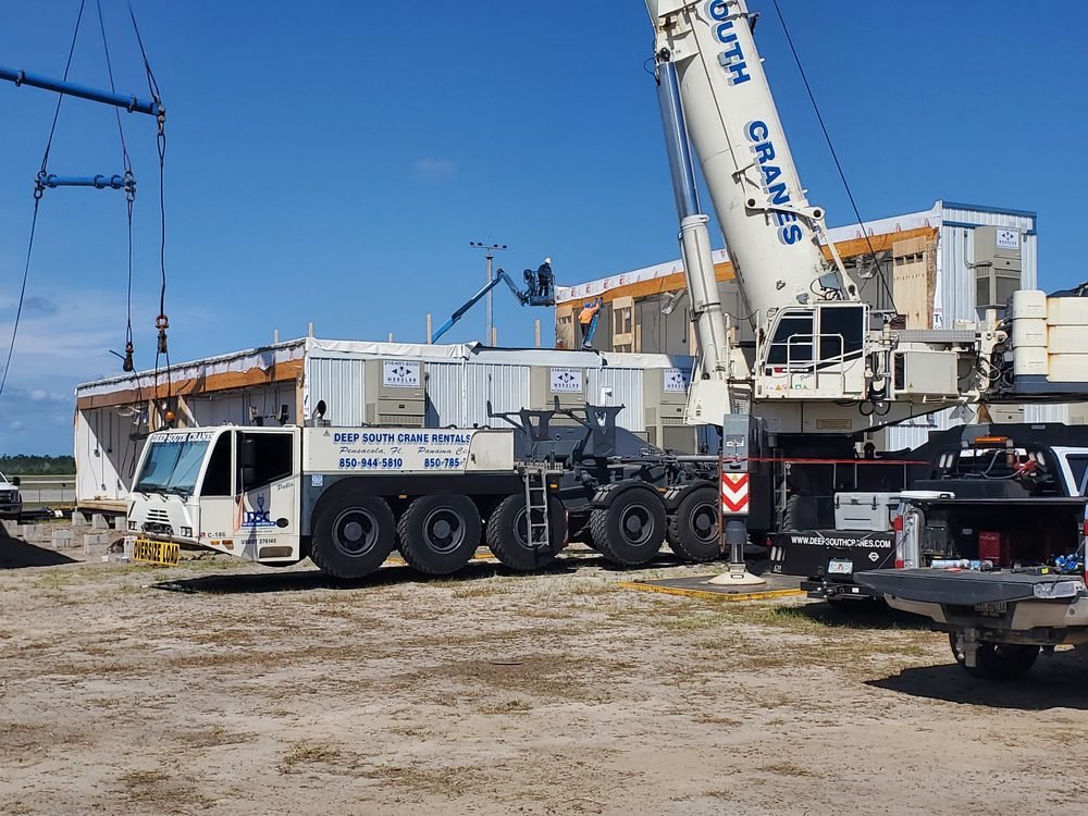 Crane and modular building units on an active commercial construction site