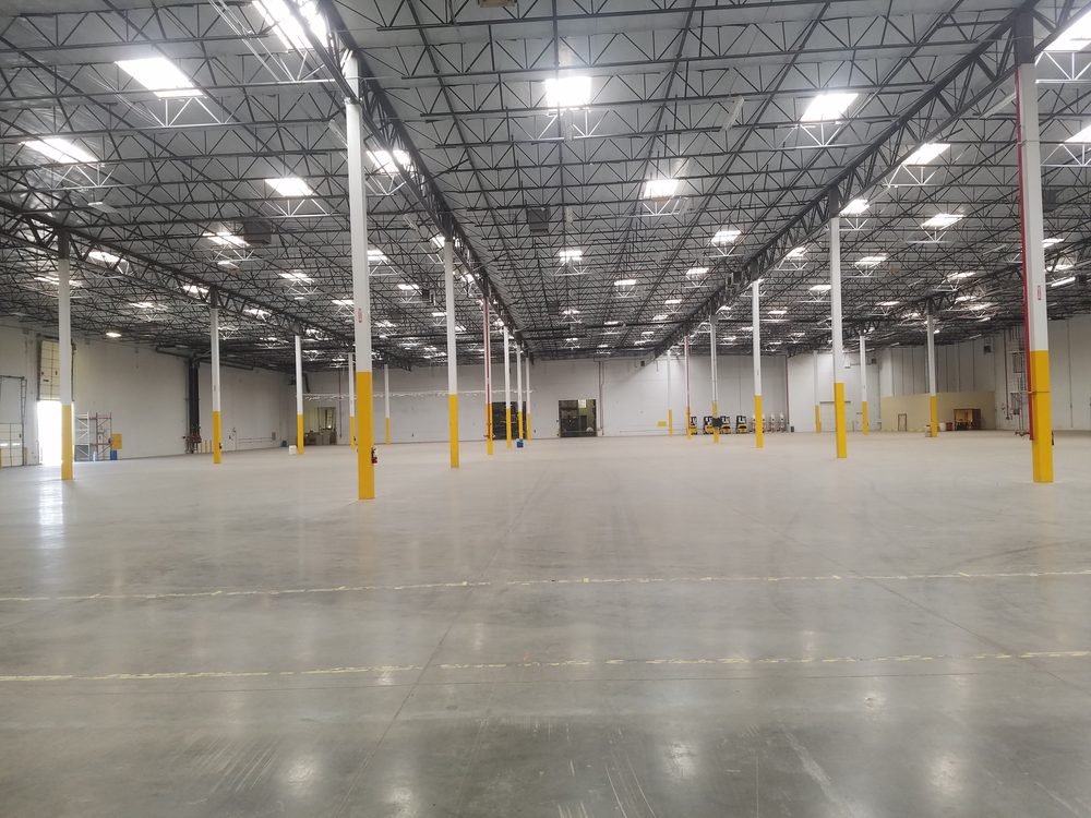 Completed high bay lighting across an empty warehouse floor